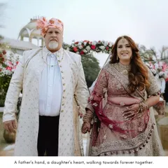 A touching moment between the bride and her father as they walk hand-in-hand, a beautiful symbol of love and support.