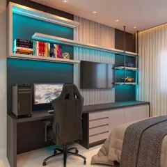 The ultimate gaming and work setup for a modern bedroom. We designed this space with a large desk, multiple shelves with blue LED backlighting, and integrated screens for a high-tech and immersive experience.