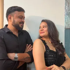 A candid, happy moment between a couple. Her smile and the elegant drape of the black saree show how confident and beautiful my outfits can make you feel.