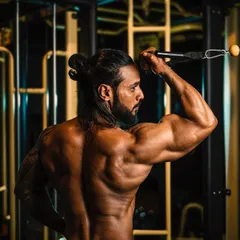 Building a strong back and defined arms with cable tricep pushdowns. Proper form here is key to sculpting the muscles.