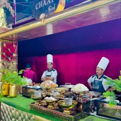 A closer view of the chaat station, showcasing the chefs and the array of ingredients ready for service.