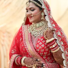 The joy of a bride on her wedding day. This close up shows her radiant smile and the beautiful harmony between the heavy kundan jewelry and the classic bridal makeup, featuring a smokey eye and a traditional bindi.