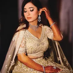 A graceful portrait of the bride-to-be adjusting her earring. We focus on these small, elegant details and candid getting-ready moments during engagement shoots.