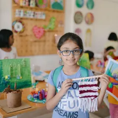Weaving is a wonderful way to learn about texture, pattern, and patience. This camper is proudly displaying the beautiful tapestry she wove during our mixed-media art camp.