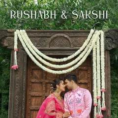 A romantic portrait of the couple in front of a traditional wooden doorway adorned with floral garlands. I help scout for these perfect photo spots within the venue.