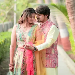 A classic and tender pre-wedding portrait. The couple is dressed in beautiful traditional attire, sharing a quiet moment on a sunlit path. It’s a timeless image that captures both their elegance and the gentle love between them.