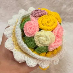 A top-down look at the vibrant, multi-colored bouquet inside one of my reversible dolls. I use a mix of pink, yellow, and cream roses to create a cheerful and full floral arrangement.