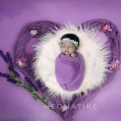 Wrapped in a heart of lavender. This overhead shot of a swaddled newborn is a beautiful and artistic way to capture their first portraits.