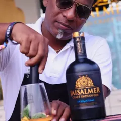 Meticulously preparing a craft gin cocktail at an outdoor festival. Every drink is made with precision and fresh ingredients, delivering a consistent, high quality experience for every guest.