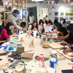 A full house for a corporate painting workshop. Our large tables can accommodate entire teams for a shared creative experience that encourages communication and collaboration.