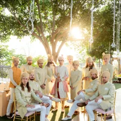 The groom and his groomsmen pose for a cool, sun-kissed group portrait. This photo captures the camaraderie and style of the groom's squad on the big day.