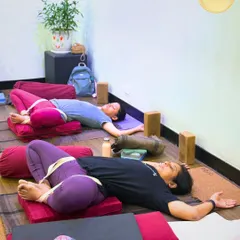 True healing is often found in rest. Here, my students use bolsters and straps in Supta Baddha Konasana, a restorative pose that gently opens the hips and calms the nervous system. This supported approach allows the body to release tension without strain, making it perfect for recovery and stress relief.