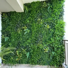 A full coverage artificial vertical garden installed on a balcony wall in Gurgaon. This design uses a dense mix of ferns and foliage to create a rich, natural look.