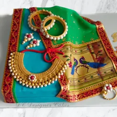 I crafted this hyper-realistic Paithani saree cake to honor a mother's birthday. The design features edible printed fabric, intricate gold jewelry, and traditional bangles, all sculpted from fondant to look just like the real thing.