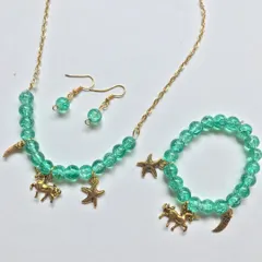 A full view of the green unicorn charm jewellery set, including the necklace, bracelet, and matching drop earrings. This whimsical set is perfect for imaginative kids.