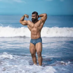 A powerful pose in the ocean, showcasing my current condition. This is what happens when you commit to the process and never give up on your goal.