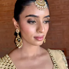 A close-up of the 'Glow Getter' look. The softly smoked-out eyes and luminous skin are perfect for a Sangeet, giving a glamorous yet effortless feel.