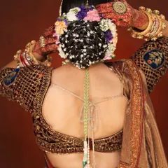 A bridal look is incomplete without the perfect hairstyle. Here, I created an intricate bridal bun, weaving in fresh flowers and delicate pearl accessories. This traditional Indian bridal hairstyle is designed to hold securely through a long day of ceremonies while looking absolutely breathtaking.