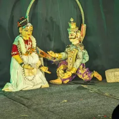 A scene of dialogue between two characters, brought to life through the art of string puppetry. The subtle movements and gestures convey the entire narrative, capturing the essence of traditional Indian theater.