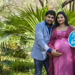 A happy couple in a beautiful park setting announcing they are having a boy. The "It's a boy" sign is a fun prop that adds a personal touch to the portrait.