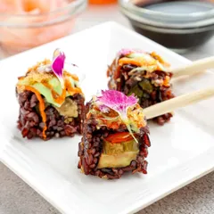 We use unique ingredients to create visually stunning dishes. This sushi is made with black rice, giving it a dramatic colour and a distinct, nutty flavour that pairs beautifully with the fresh vegetable fillings.
