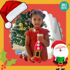 A young participant proudly holds the Santa themed bottle art she created during our Christmas party. It's a wonderful, handmade decoration to take home for the holidays.
