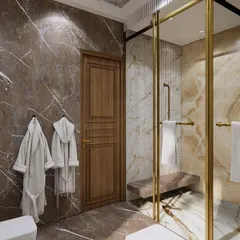 This master washroom features rich marble and a glass shower enclosure. The separation of wet and dry areas is a key functional and Vastu principle, helping to contain moisture and maintain a clean, hygienic environment.