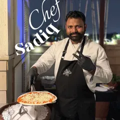Chef Sadiq at our live pizza station, ready to craft the perfect slice. Our team brings energy and skill to every event.