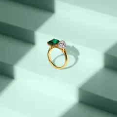 This clean, geometric composition features a stunning emerald and diamond ring against a stepped, mint-green background. Our jewellery photography focuses on sharp details, accurate color, and creative staging to highlight the premium quality of each piece.