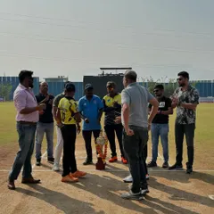 The captains and officials gather at the pitch for the toss before the start of the Disha Premier League U-14 match.
