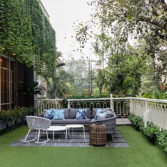 This terrace was designed as a comfortable outdoor living room. A vertical garden wall provides a lush green backdrop, making the space feel like a private oasis despite being in a dense urban environment.