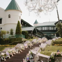 The entrance to the ceremony was a grand staircase lined with cascading pastel floral arrangements and candles. This created a breathtaking path for the bride, building anticipation for the moment she would walk down the aisle.