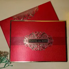 This rich crimson invitation makes a bold statement with its textured finish and an ornate, embossed gold nameplate.