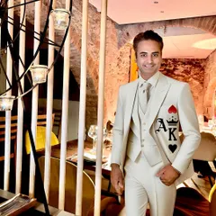 For this client, I created a custom monogram design with the Ace and King of hearts on a sharp, all-white three-piece suit. It’s a subtle yet bold statement, hand-painted to add a touch of personal flair to formal wear.