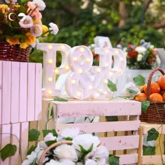 For a citrus-themed baby shower, we created this fun decor piece with light-up marquee letters. The rustic crates, fresh oranges, and floral baskets added to the "pulp-fect" theme.