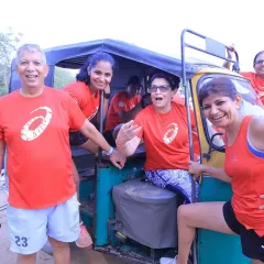 All smiles and fun during a team activity involving an auto-rickshaw. Our fitness challenges are filled with laughter and memorable moments.
