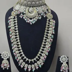 A beautiful pastel-colored set with a choker and matching rani haar, featuring a unique crescent moon design.
