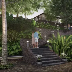 To make the steep backyard of the Nilaya Residence accessible, I designed a series of tiered levels connected by stone stairways. This practical solution also creates a visually appealing journey down to intimate seating areas nestled in the lush landscape.