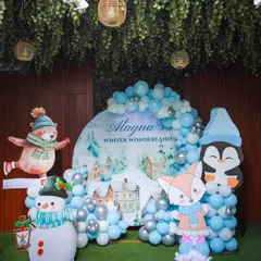 Welcome to a Winter Wonderland. This theme features adorable animal cutouts like a fox and snowman, and a beautiful balloon arch in shades of icy blue and silver to create a magical, snowy scene.