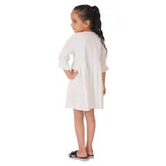 The back view of the white frock, essential for showing details like buttons or ties.