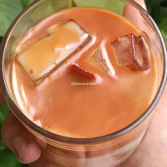 I created this hyper-realistic iced coffee candle for all the coffee lovers out there. It's made with layered soy wax to mimic the look of milk and coffee, complete with wax ice cubes, and fills the room with a rich coffee aroma.