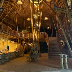 The central light fixture and multi-level structure of this bamboo building in Bali are a testament to the structural and aesthetic possibilities of natural materials.