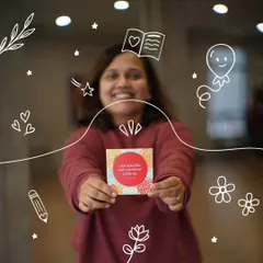 A participant proudly displays an affirmation card. Our workshops provide tools and practices to help you nurture more positive self talk in your daily life.