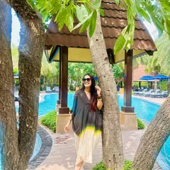A still shot from the resort, where the stack of dark wooden bangles on my wrist adds a beautiful, earthy contrast to the poolside setting.