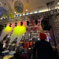 Behind the full percussion setup, ready to kick off a super hit wedding show. The combination of lights, smoke effects, and live beats creates an immersive experience for guests.