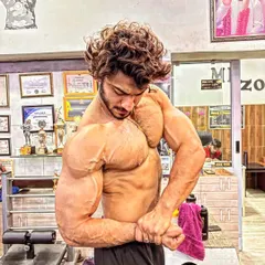 A side chest pose showing the thickness of my pecs and the size of my arms. This is a power pose that displays pure mass.