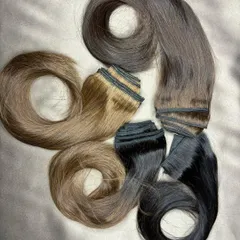 A beautiful array of my clip-on hair extensions, showcasing the different natural colors and shades available to create the perfect match for you.
