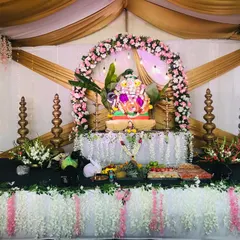 The main stage we designed for a Ganesh Chaturthi celebration. The setup features a beautiful floral arch, traditional brass lamps, and an elegant backdrop for the Ganesha idol, creating a divine centerpiece for the festival.