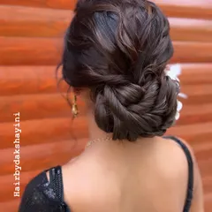This is a classic example of a textured low bun. It's one of the most versatile updos, and I teach how to create it with soft, natural-looking volume.