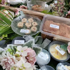 A close-up of our breakfast hamper contents, showing individual portions of Malai, butter, sugar, and our homemade 'Gud ka Sandesh' and Marmalade Bread.
